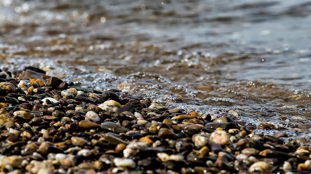 stones near the beach seashore during day time